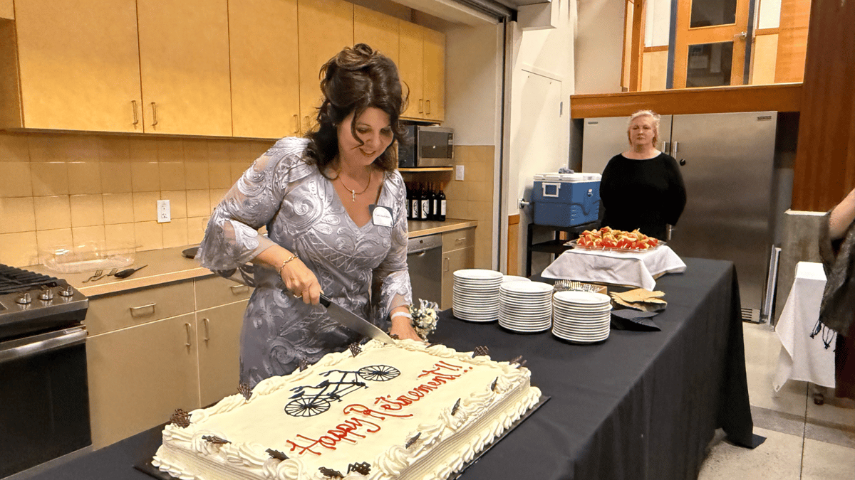Leah MacKenzie cutting her retirement cake